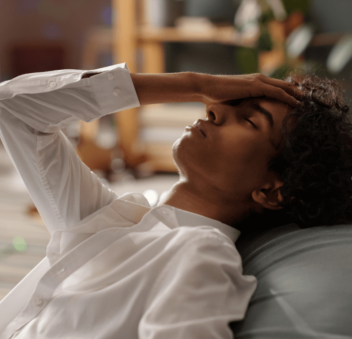 man stressed on couch about Quarter Life Crisis Symptoms
